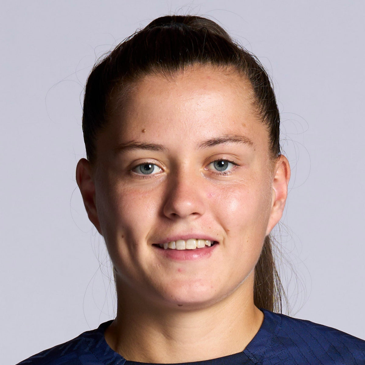 Person wearing a Barcelona FC sports jersey with Nike logo on a plain background